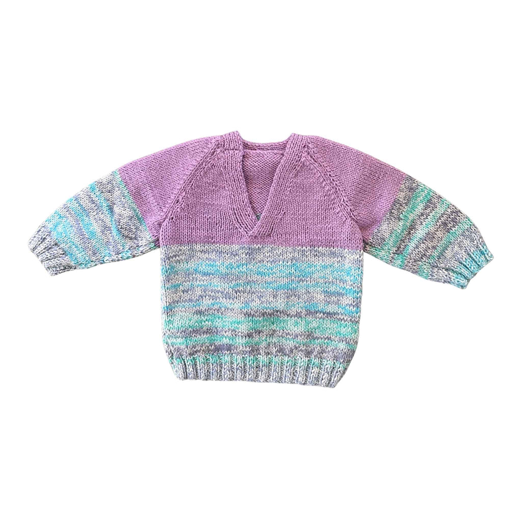 Knitted sweater with purple and multicolor pattern on a white background