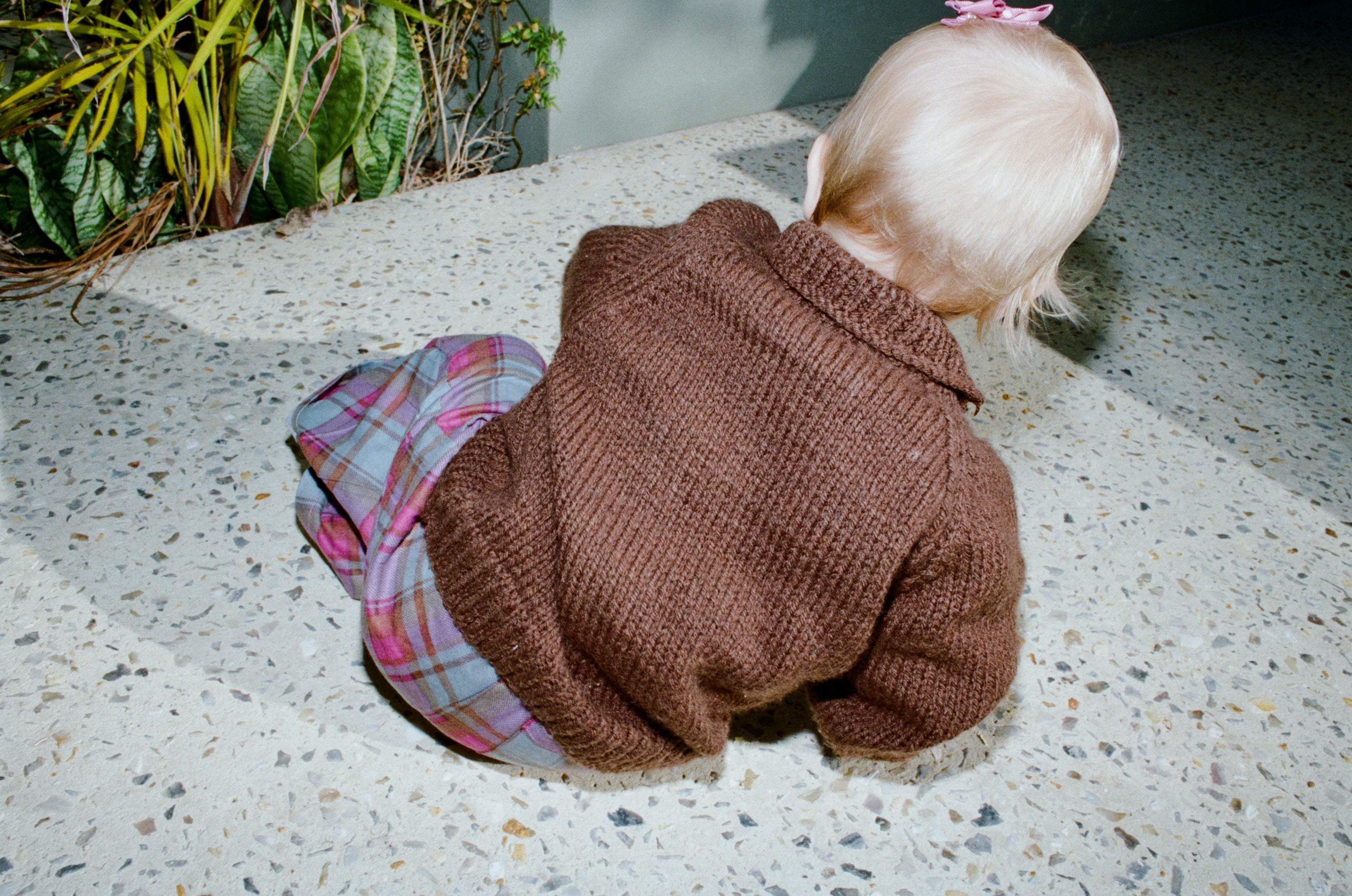 A child in a handknitted brown jumper